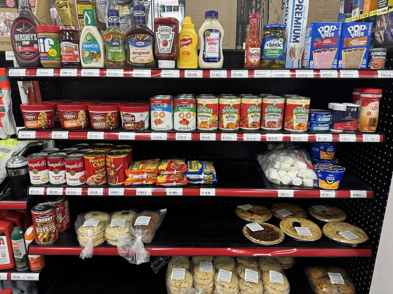 Pies, packaged baked goods, groceries and pantry items on shelves at Jack's
